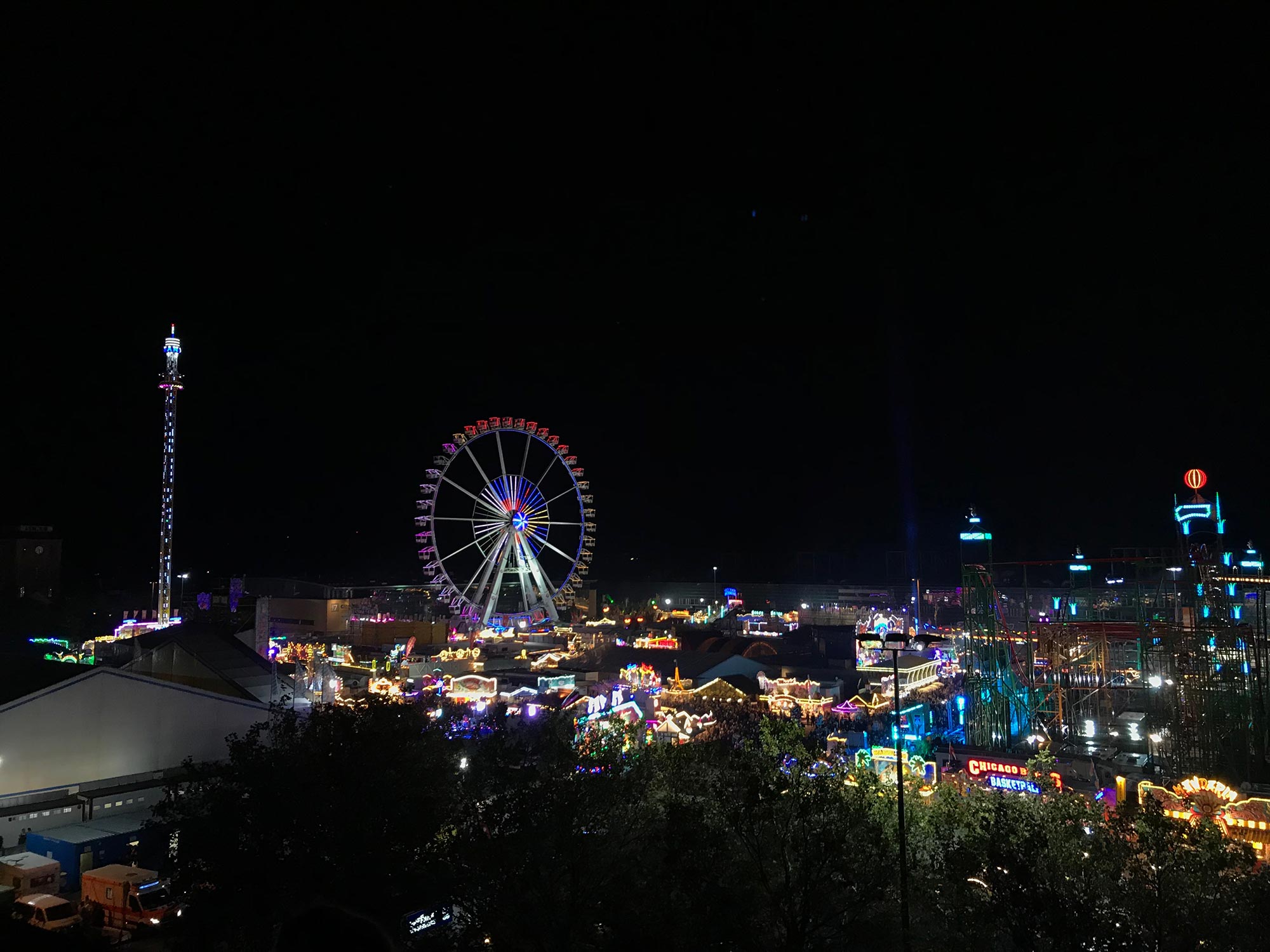 A fairground in Bremen City by night with many lights coming from the giant wheel