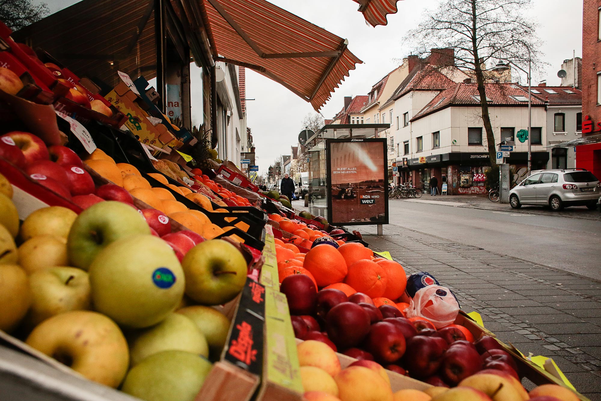 Detail of apples, oranges, pears and other fruit presented in front of a store