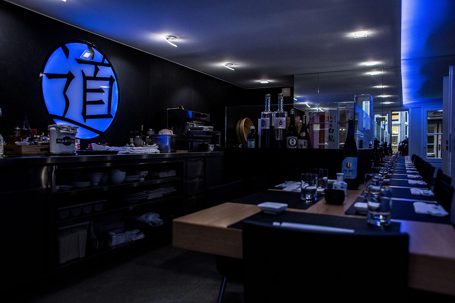 A dark bar with blue colours and Asian symbols