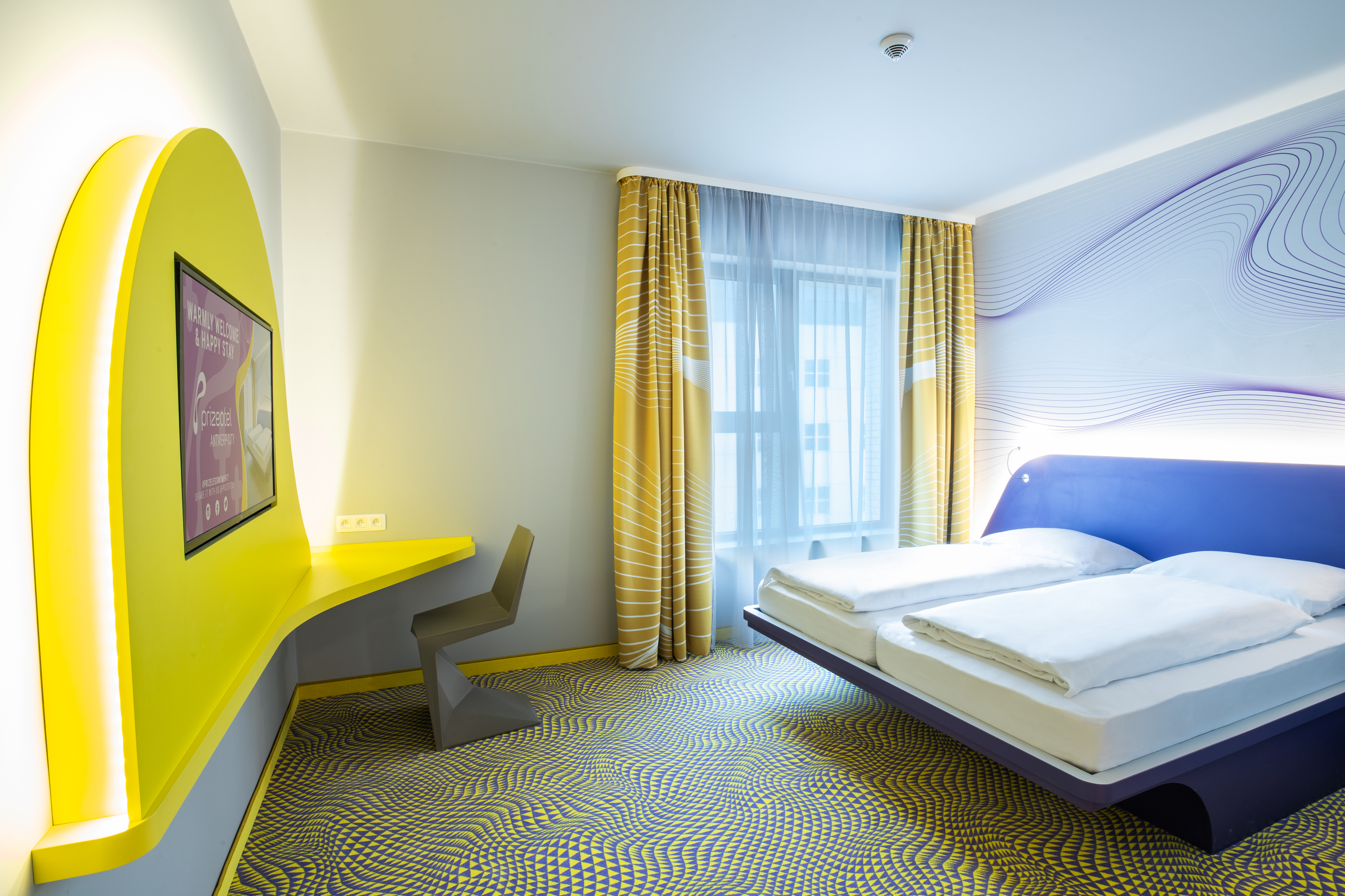 Hotel room of prizeotel Antwerp City in warm colors