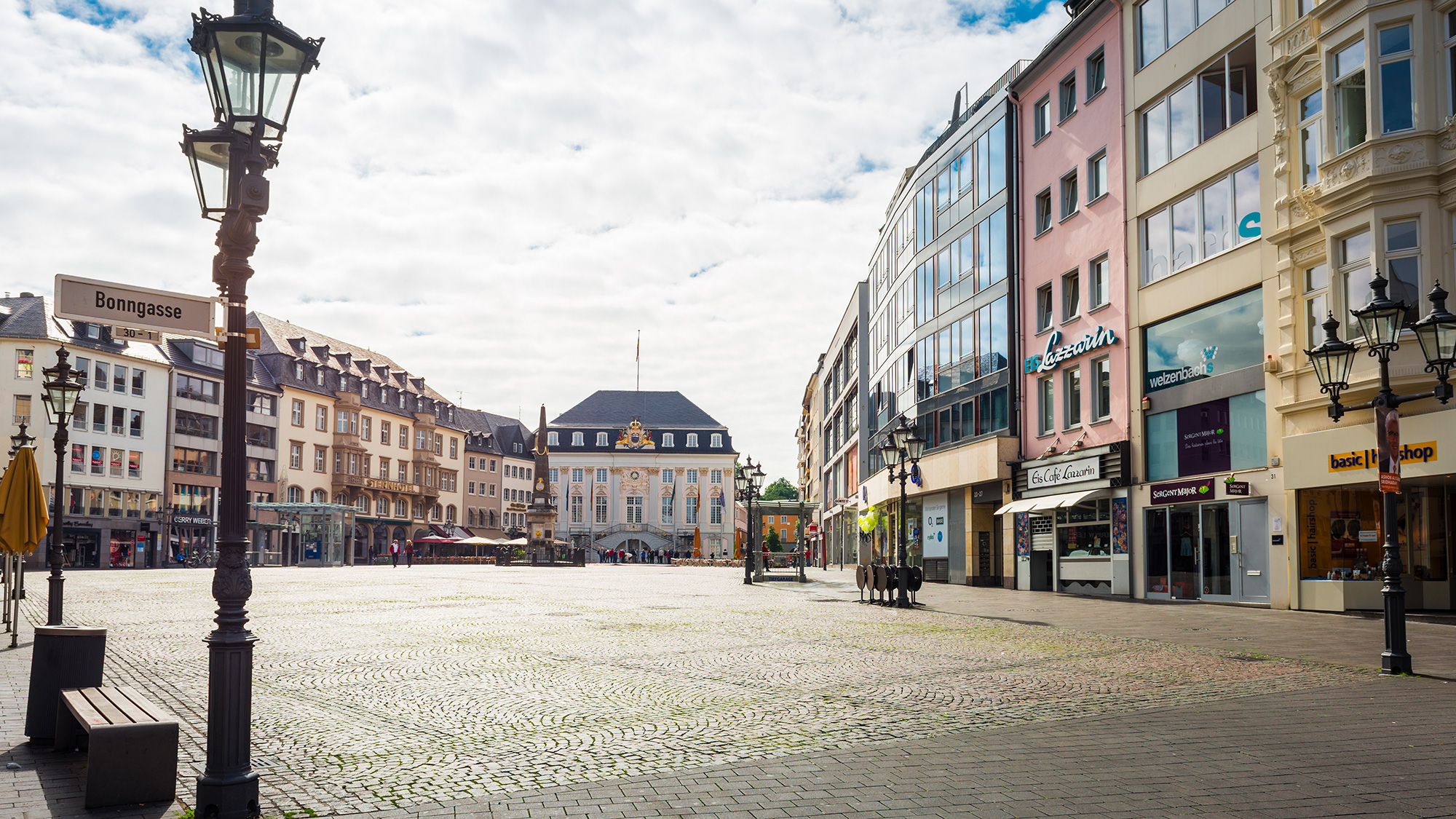 Empty market place in Bonn-City with many shops in the background
