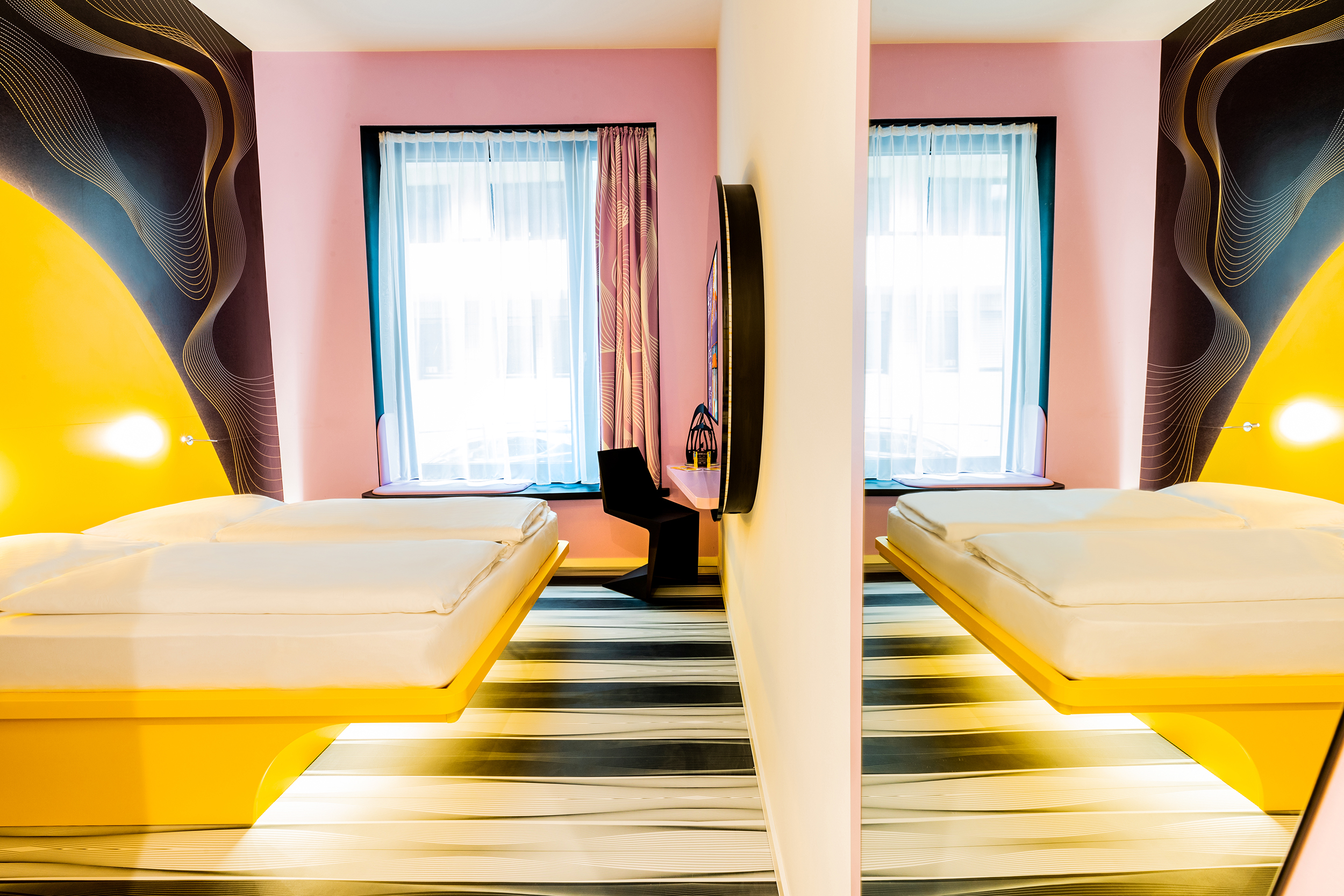Eine Zweibettzimmer mit gelben Betten und einer Trennwand