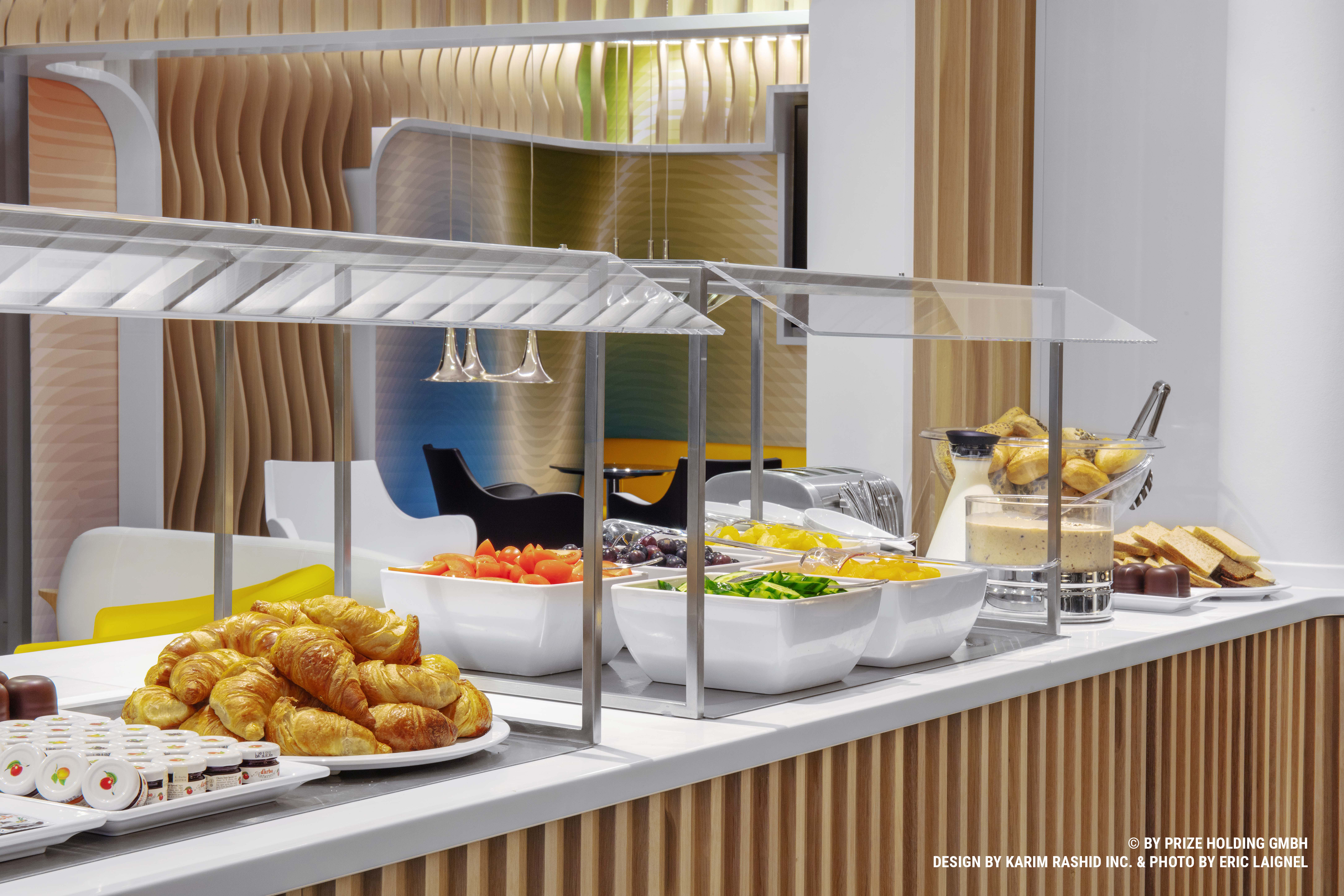 Breakfast buffet in prizeotel Bremen-City with raw vegetables, croissants and sweets