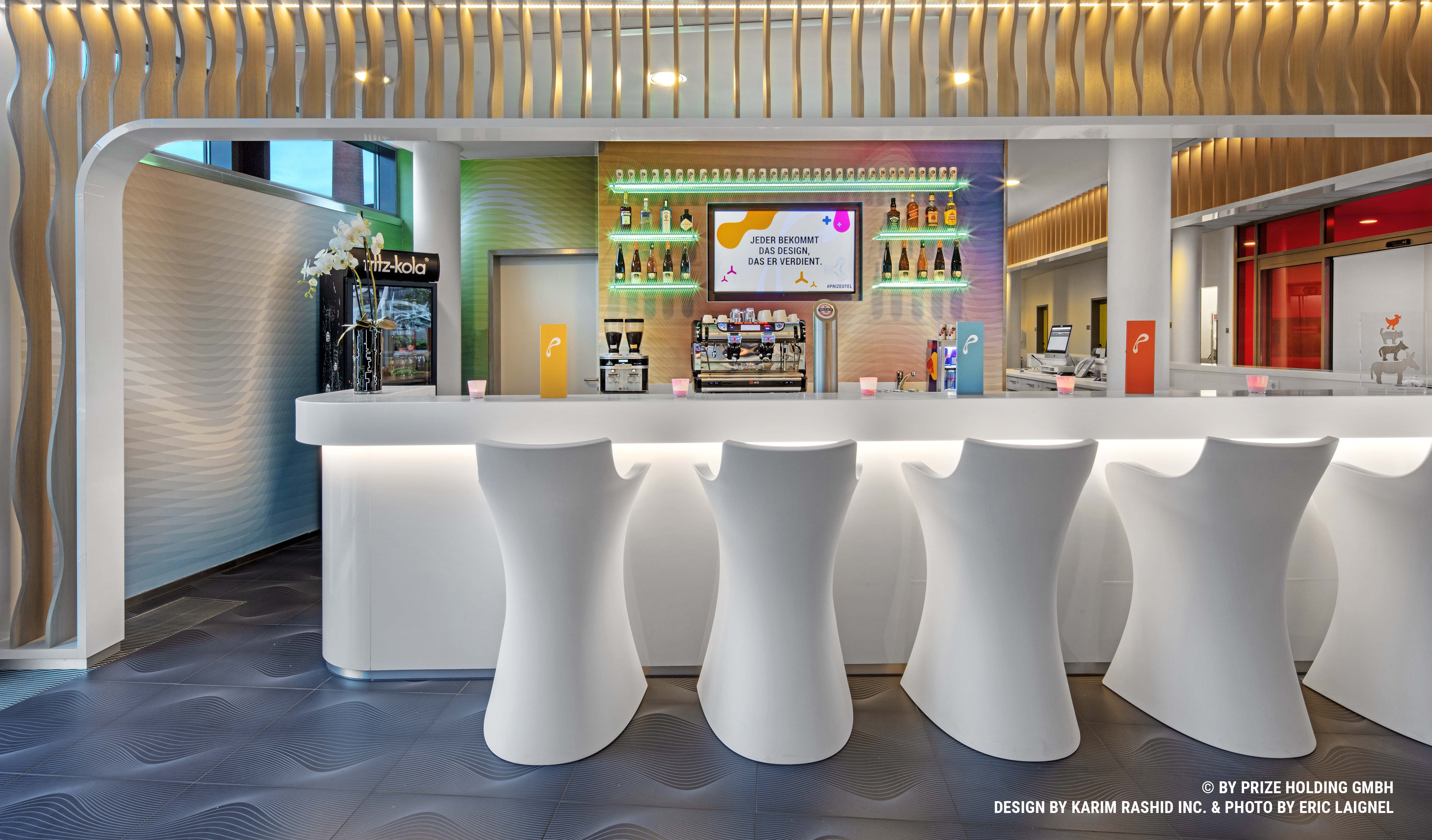 Hotel bar with white stools and a white counter