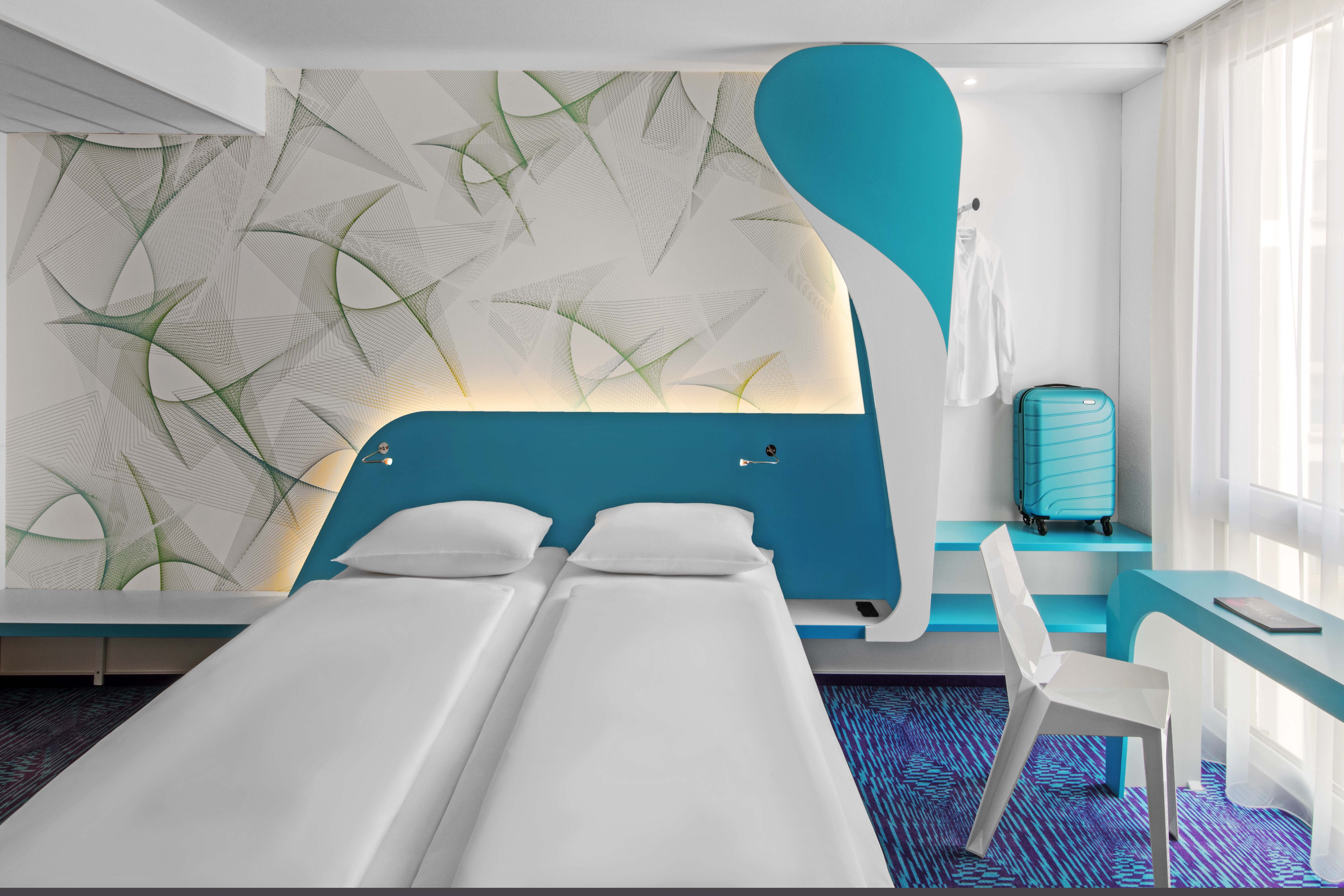 Design hotel room with light blue colours and patterns on the wall