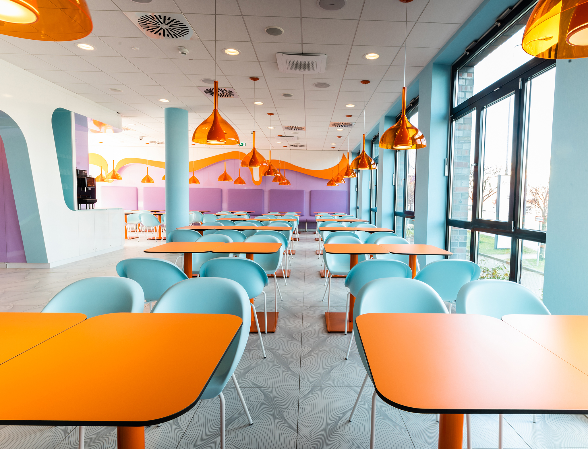 The modern dining room of the Hotel in Rostock in blue and orange